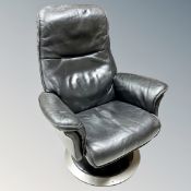 A Scandinavian swivel relaxer chair in black leather