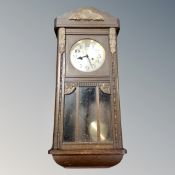 A 20th century eight day wall clock with pendulum