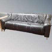 A Scandinavian black leather contemporary settee on metal legs,