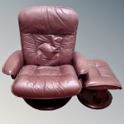 An Ekornes Stressless Burgundy leather swivel relaxer armchair with stool