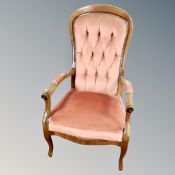 A Victorian style open armchair in pink buttoned dralon