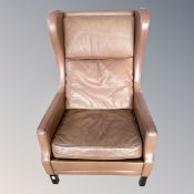 A 20th century Scandinavian wingback armchair in brown leather