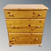 A pine three drawer chest