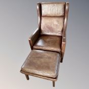 A 20th century Scandinavian brown leather wingback armchair and stool