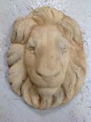 A concrete garden lion mask wall plaque