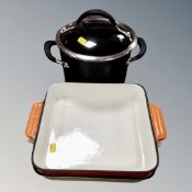 A lidded twin-handled cooking pot and two further Le Creuset dishes