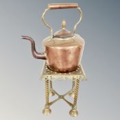 A Victorian copper kettle and brass kettle stand