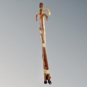 A bundle of five wooden walking sticks including a tribal example