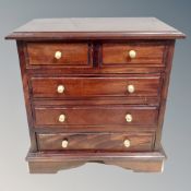 A Victorian style hardwood five drawer low chest