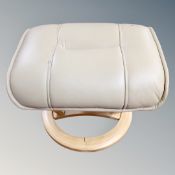 A Scandinavian cream leather footstool on circular base