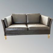 A Scandinavian brown leather two seater settee