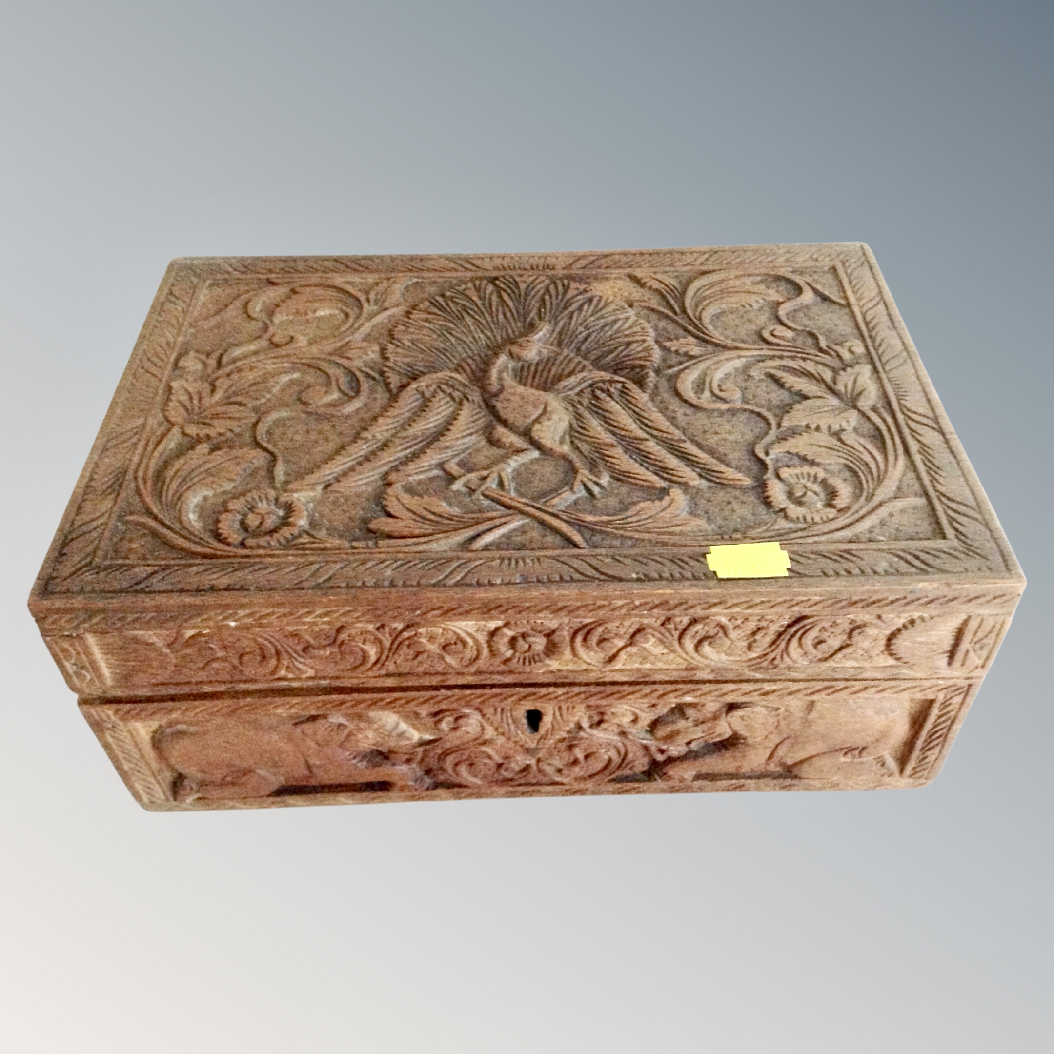 An Eastern heavily carved oak jewellery box
