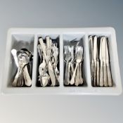 A tray of stainless steel flat ware.