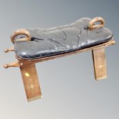 A brass inlaid camel stool