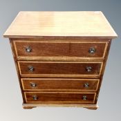 An inlaid mahogany four drawer low chest,