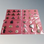 Thirty-six British Army cap badges mounted on card