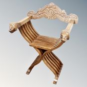 A reproduction Savonarola armchair