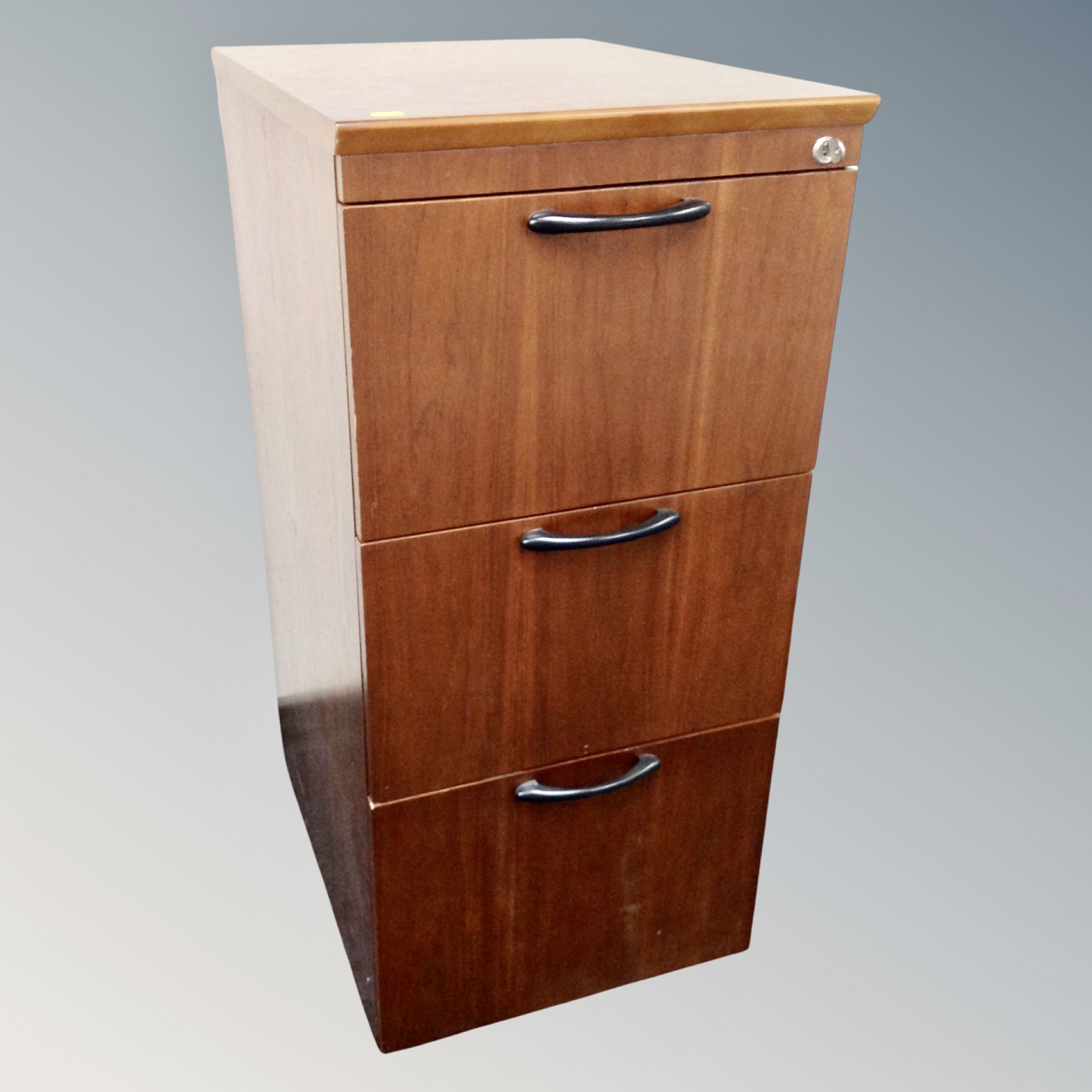 A contemporary filing cabinet with key