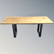 An oak refectory table on metal base,