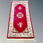 A Chinese rug on red ground,
