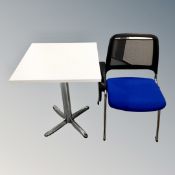 A white pedestal table together with a mesh back and fabric study chair with adjustable tray