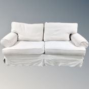 A contemporary two seater settee in cream upholstery length 197 cm