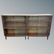 Three mahogany effect sliding glass door bookcases