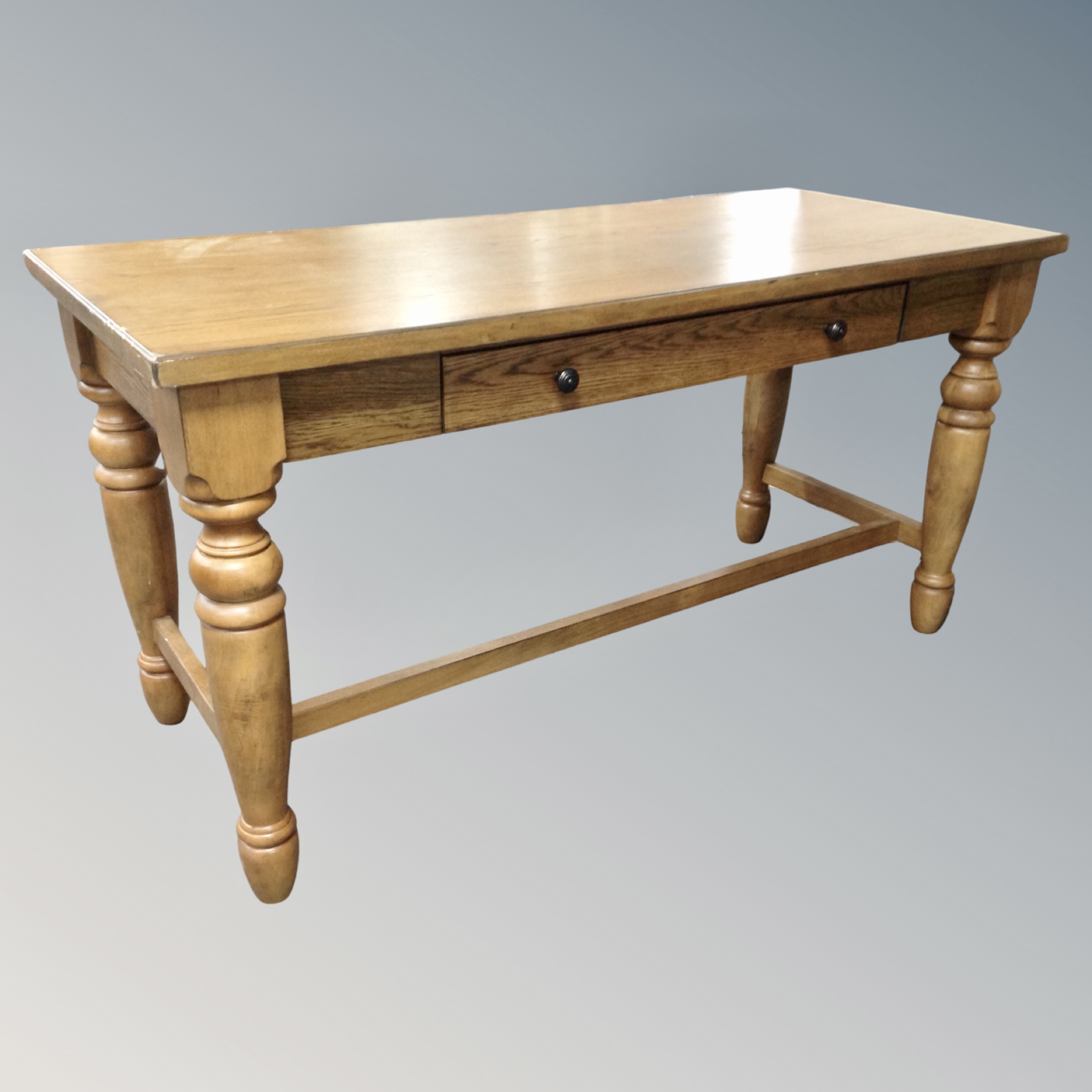 A contemporary refectory office table with pull out drawer slide in oak finish