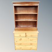A pine chest of five drawers and a reproduction mahogany open bookcase