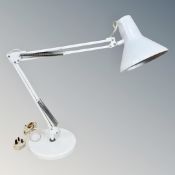 A metal angle poise lamp