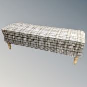 A storage ottoman in checkered fabric