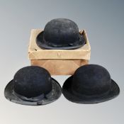 Three vintage bowler hats and a vintage cardboard hat box