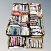A pallet of seven boxes of mainly hardbacked books relating to war, novels,