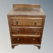 An Edwardian oak three drawer chest,