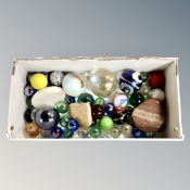 A box of glass marbles and polished stone samples