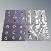 Thirty-six British Army cap badges mounted on card