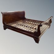 A mahogany effect 6' sleigh bed
