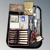 A tray of cased butter knives, Meersham pipe, vintage razor, cuff links, badges,