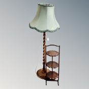 An oak cake stand together with a barley twist standard lamp