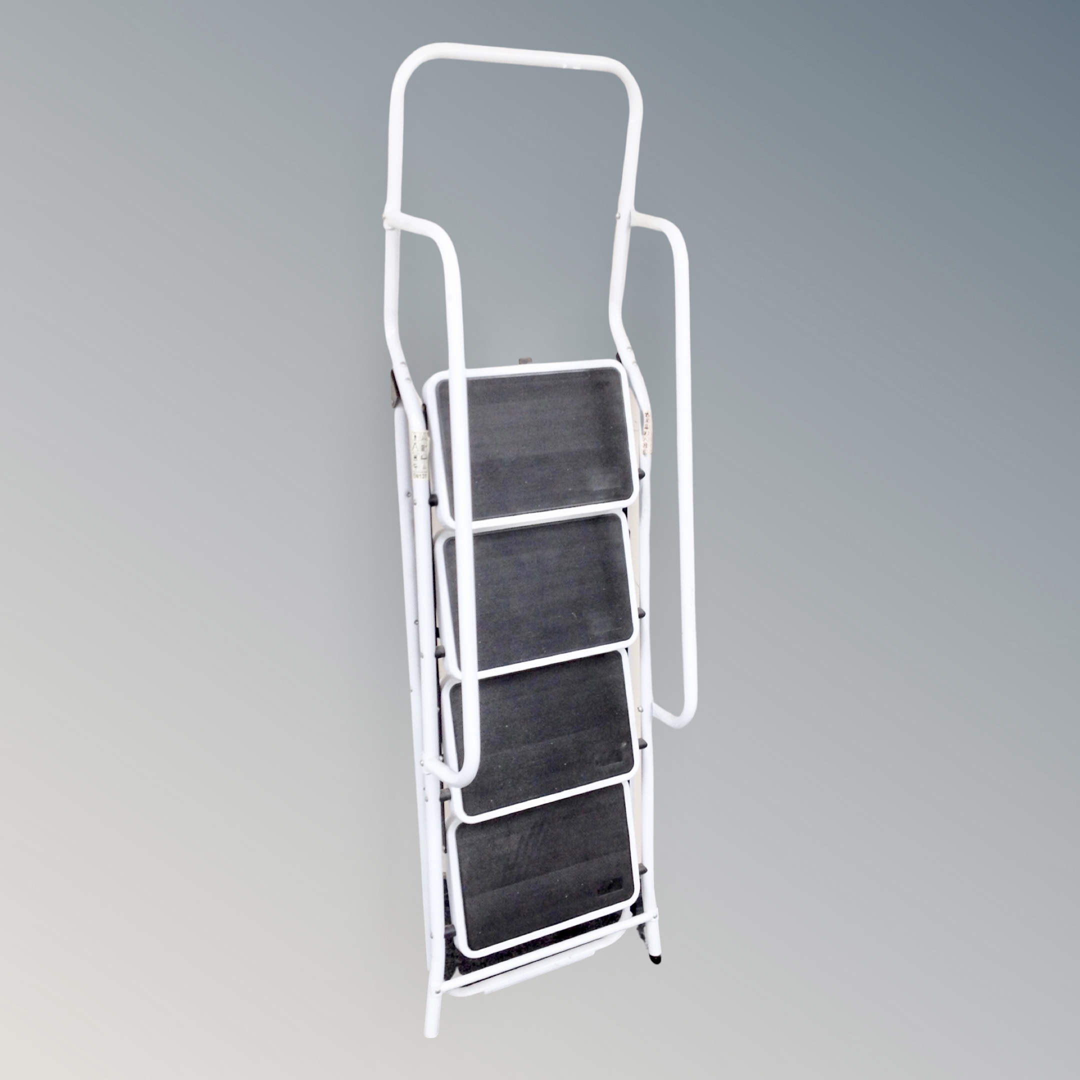 A four tread folding step ladder with double hand rail