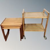 A 1970's nest of teak tables together with a 1970's teak effect drinks trolley,