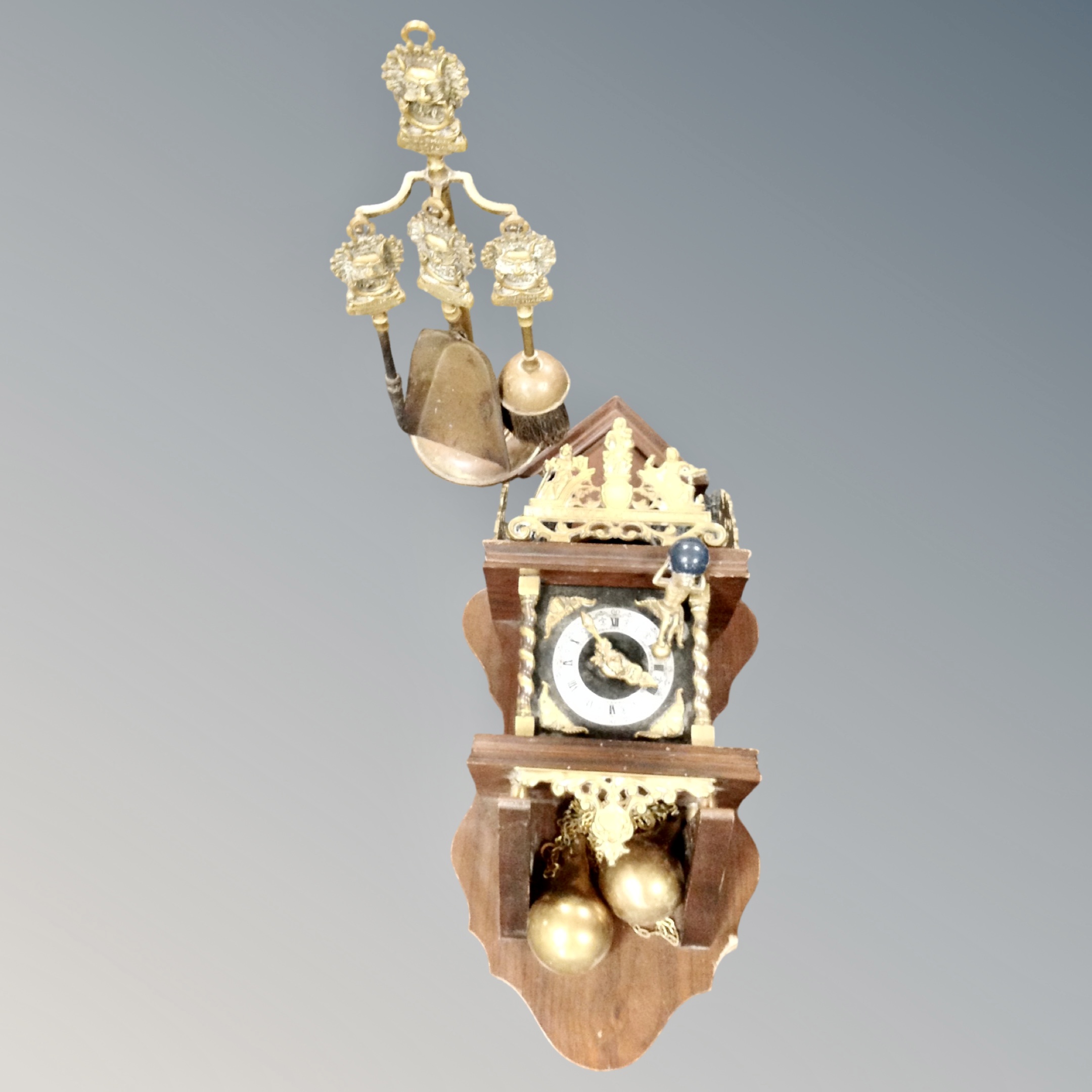A continental wall clock with brass pear drop weights,
