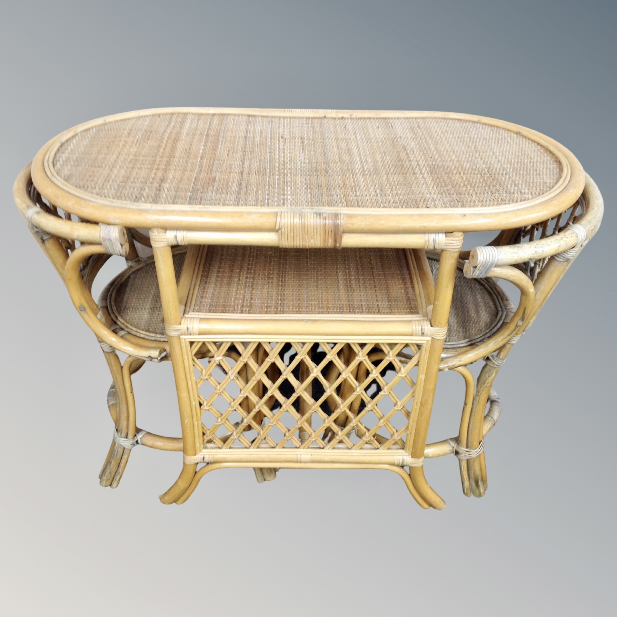 A bamboo and wicker table with two matching chairs