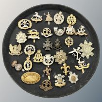Thirty assorted cap badges of various regiments.