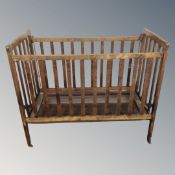 A 20th century beechwood cot