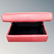 A red leather storage footstool