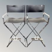 A pair of contemporary black stitched leather and chrome high chairs