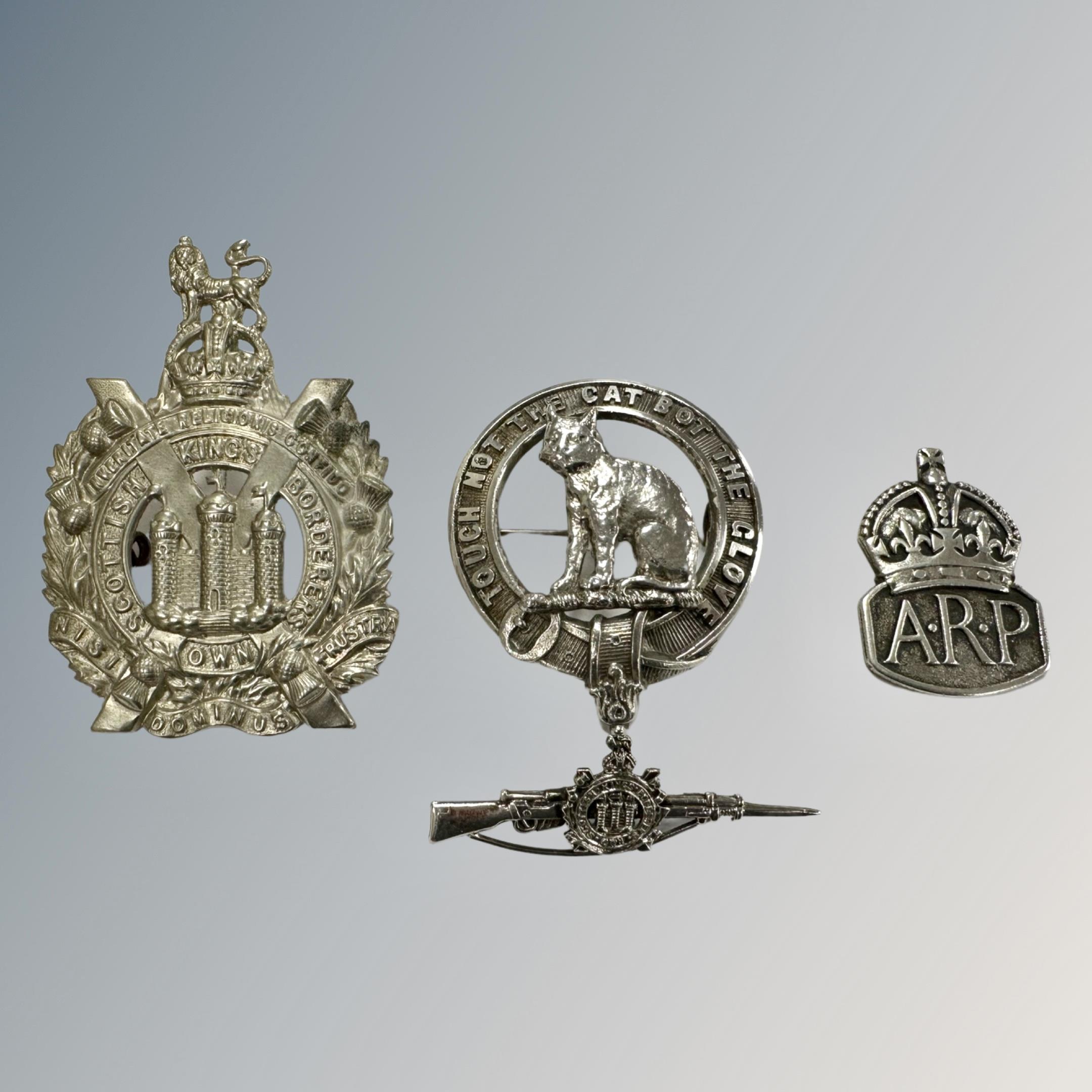 A silver Macpherson clan badge, Mackay & Chisholm, Edinburgh 1952, together with a silver ARP badge,