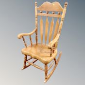 A contemporary spindle backed rocking chair
