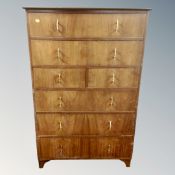 A teak effect seven drawer chest,